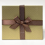 Load image into Gallery viewer, An image of a gold gift box with brown ribbon with white dots
