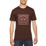 Load image into Gallery viewer, Men&#39;s brown - A man wearing a tshirt with a white letterpress chocolate logo
